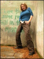 Curvy,  kinky Trixie wields her big strap-on she-cock outside.