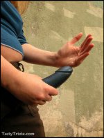 Curvy,  kinky Trixie wields her big strap-on she-cock outside.