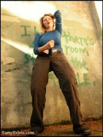 Curvy,  kinky Trixie wields her big strap-on she-cock outside.