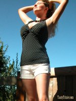 Busty woman Trixie shows off and strips outside.